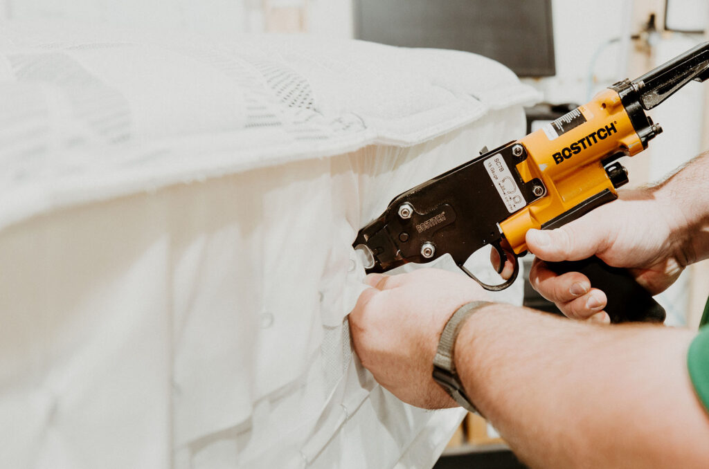 TMM employee hand crafting a mattress